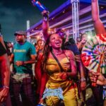 Crowd of festival-goers dancing at night at an Afro Future event