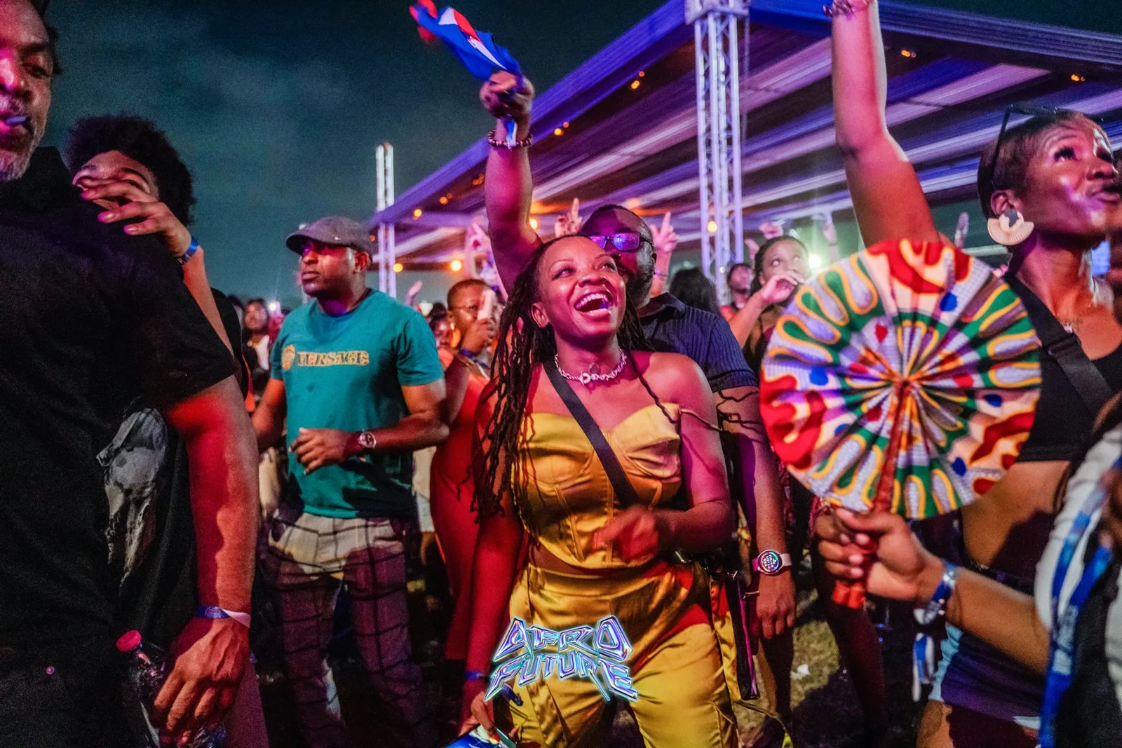 Crowd of festival-goers dancing at night at an Afro Future event