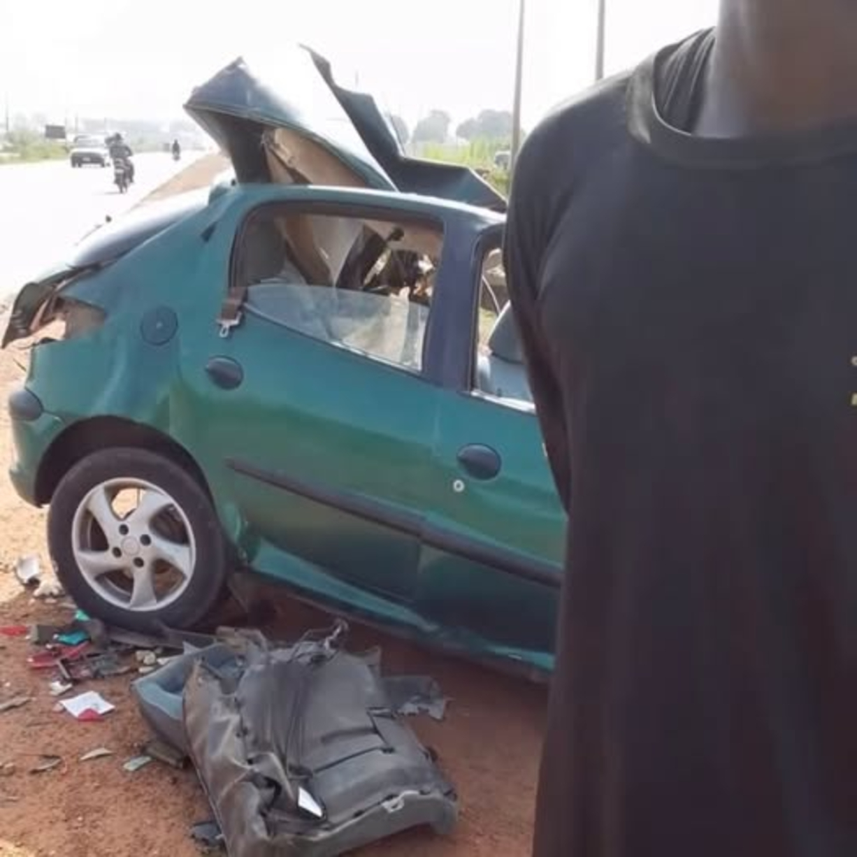 Wrecked green car on the roadside in Minna after a crash involving the Niger State governor’s convoy